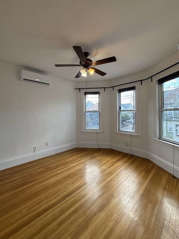 32-34 Etna Street, Unit 2 Boston, MA 02135 - Photo 5 of 12 a view of an empty room with window and wooden floor