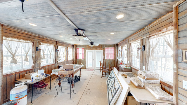 718 South State Street Genola, UT 84655 - Photo 6 of 19 Enclosed porch featuring wood-panel walls, multiple windows, a light-colored ceiling, and recessed lighting