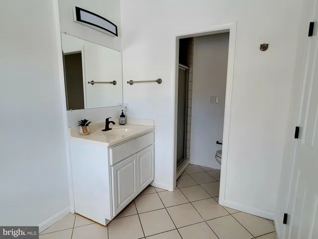 a view of a room with wooden floor and white walls