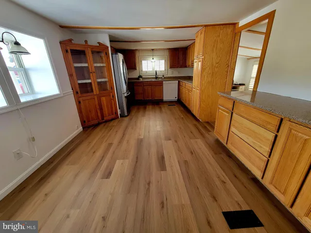 a kitchen with stainless steel appliances a refrigerator and a stove top oven