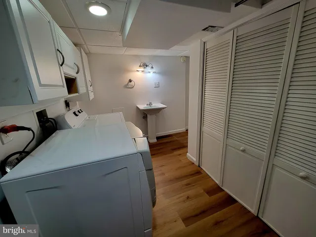 a view of a big room with wooden floor and windows