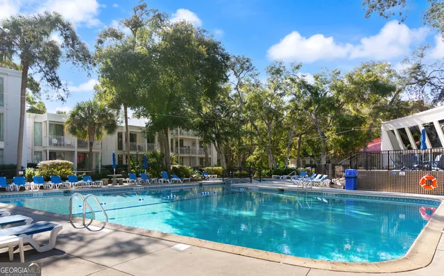 a view of swimming pool is middle in the garden