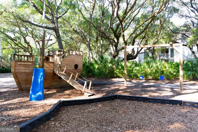 a view of a park that has a tree on the side of the house