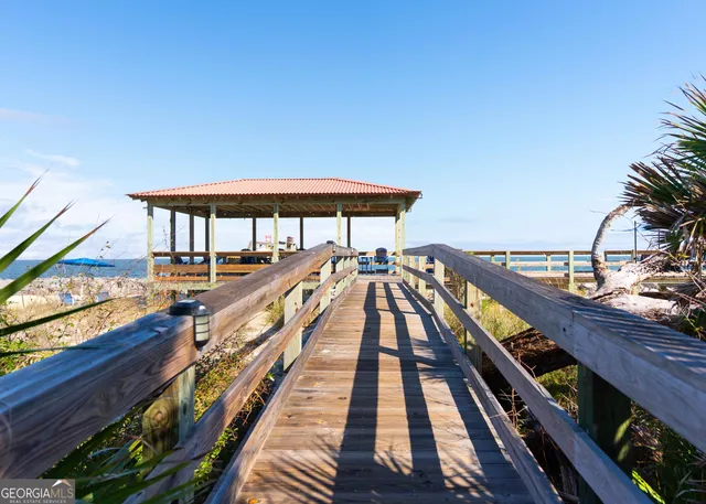 a view of balcony with wooden floor and fence