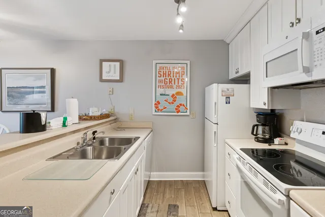 a kitchen that has a sink and a stove in it