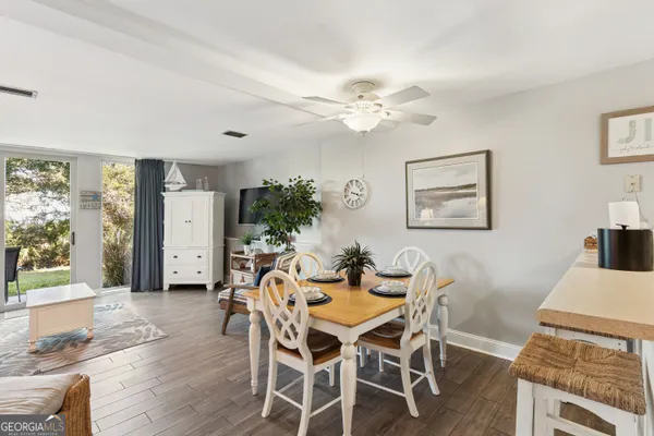 a view of a dining room with furniture and a chandelier
