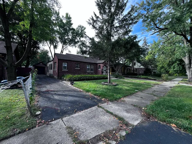 a view of a house with a yard and tree s