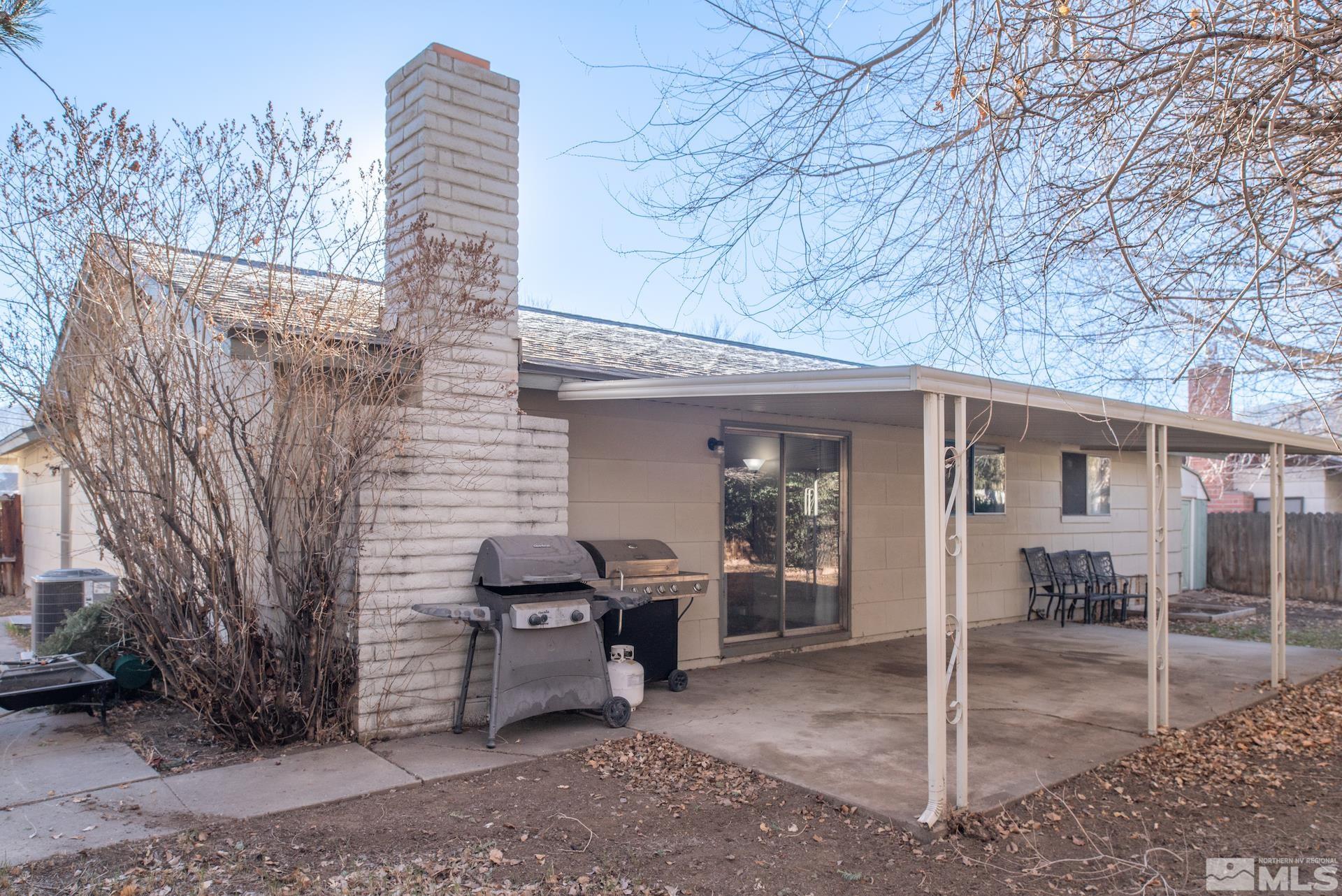 2995 Bobby Drive Reno, NV 89502 - Photo 17 of 17 a view of a patio with table and chairs next to a large window