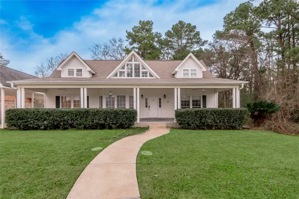 a front view of a house with a garden and yard