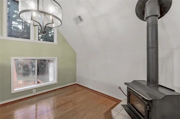 a view of a room with wooden floor and cabinet