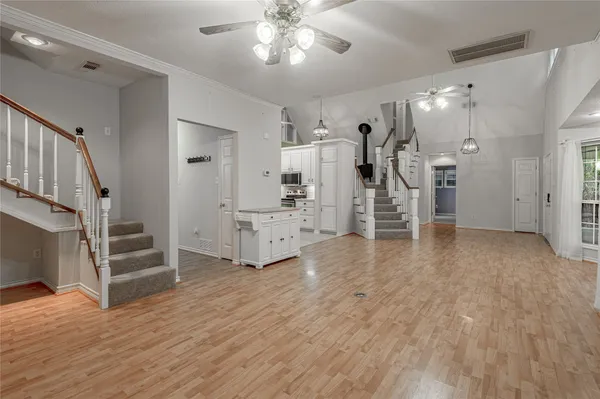 a view of a room with wooden floor and stairs