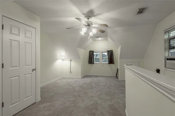 a view of a livingroom with a ceiling fan and a chandelier fan