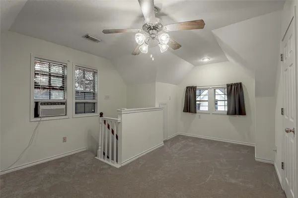 an empty room with windows and entrance