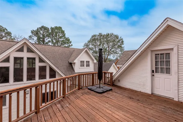 a view of a house with wooden deck