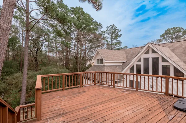 a view of a house with wooden deck