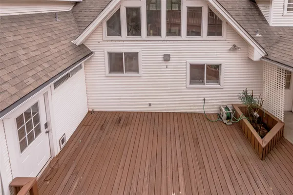 a view of a house with wooden deck