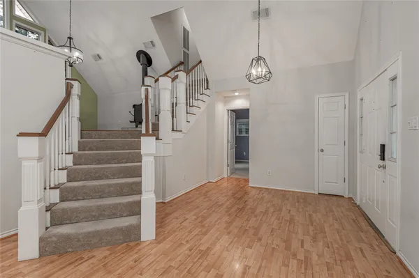 a view of an entryway with wooden floor