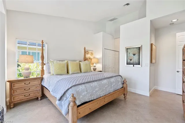 a bedroom with double bed and a chandelier