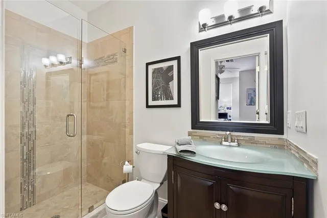 a bathroom with a double vanity sink toilet and shower