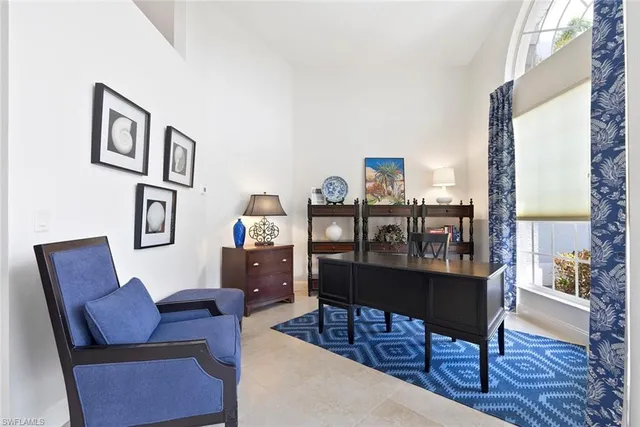 a living room with lots of furniture and view of kitchen