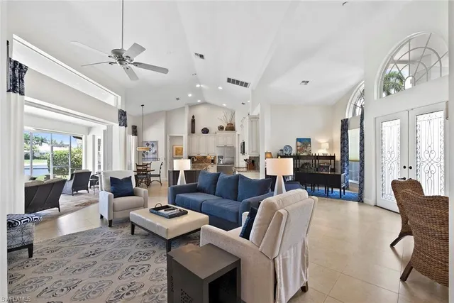 a living room with furniture a flat screen tv and a window