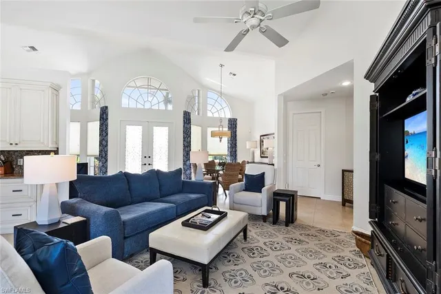 a large kitchen with stainless steel appliances a stove a sink a oven a table and chairs