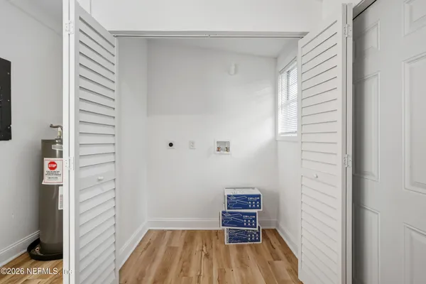a view of room with stairs and wooden floor