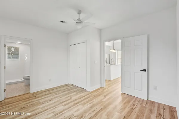 a view of an empty room and wooden floor