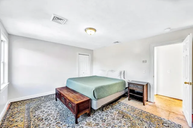 a living room with a bed and a rug