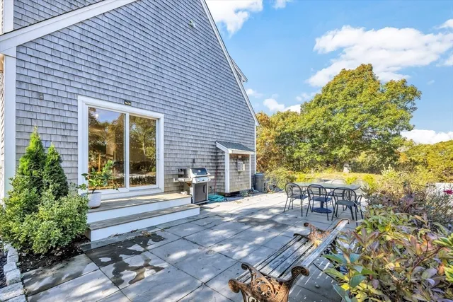 a view of a patio with table and chairs and potted plants