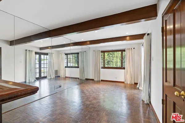 a view of a big room with wooden floor windows and livingroom