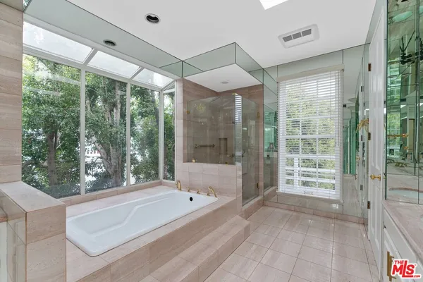 a spacious bathroom with a large tub and shower