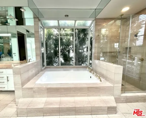 a bathroom with shower and bathtub