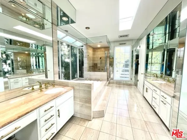 a large white kitchen with a large window