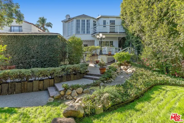 a view of a garden with a house