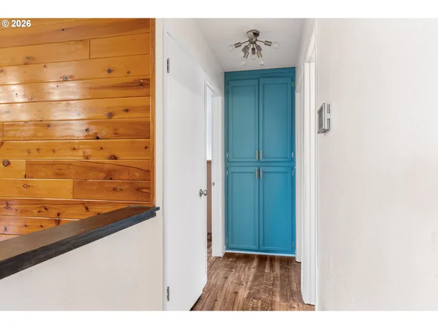 a room with a wooden floor and a window