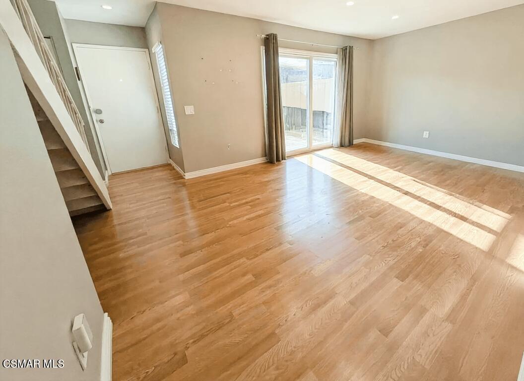 28713 Conejo View Drive Agoura Hills, CA 91301 - Photo 4 of 28 a view of an empty room with wooden floor and a window