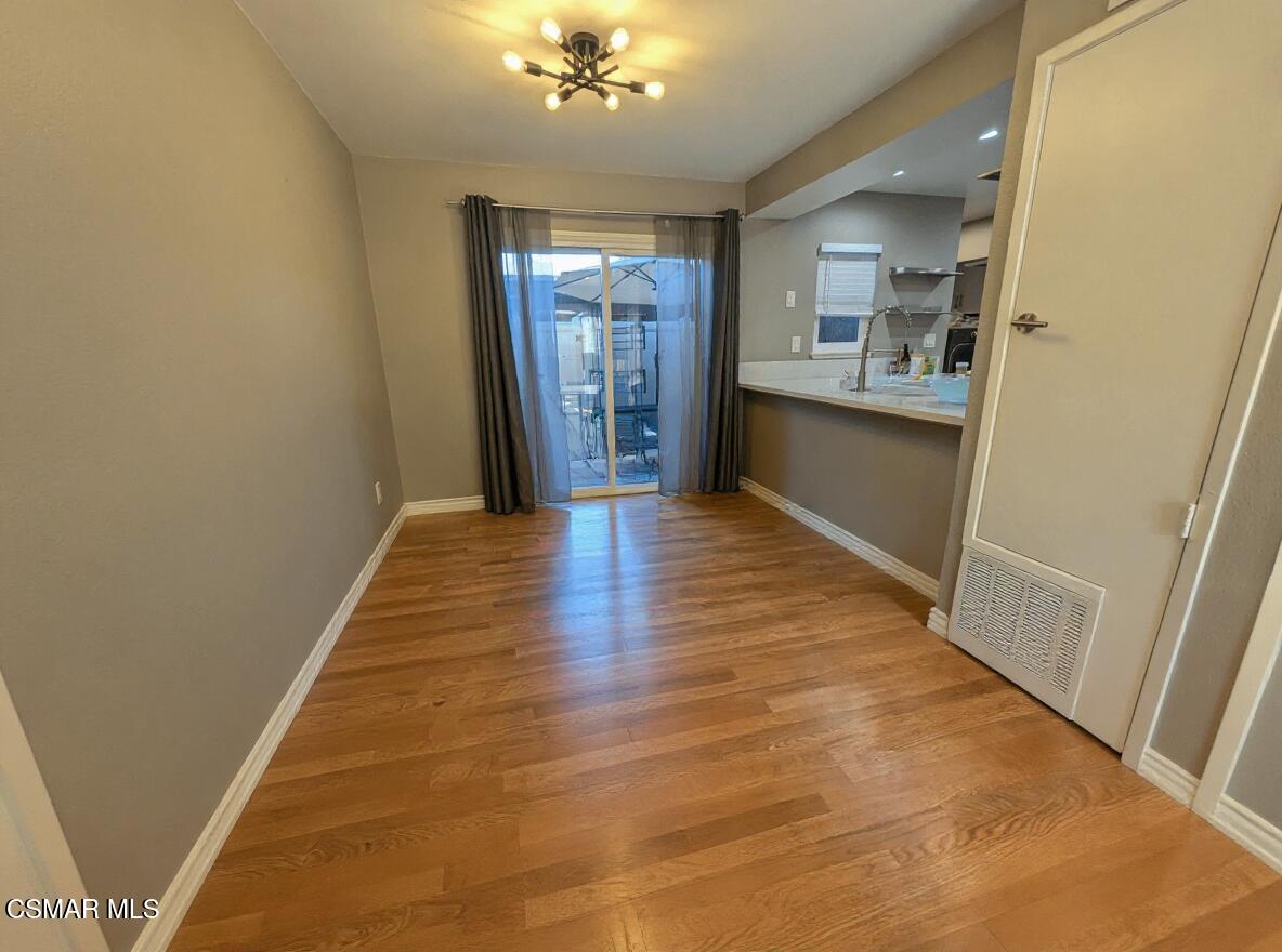 28713 Conejo View Drive Agoura Hills, CA 91301 - Photo 7 of 28 a view of a hallway with wooden floor and a kitchen