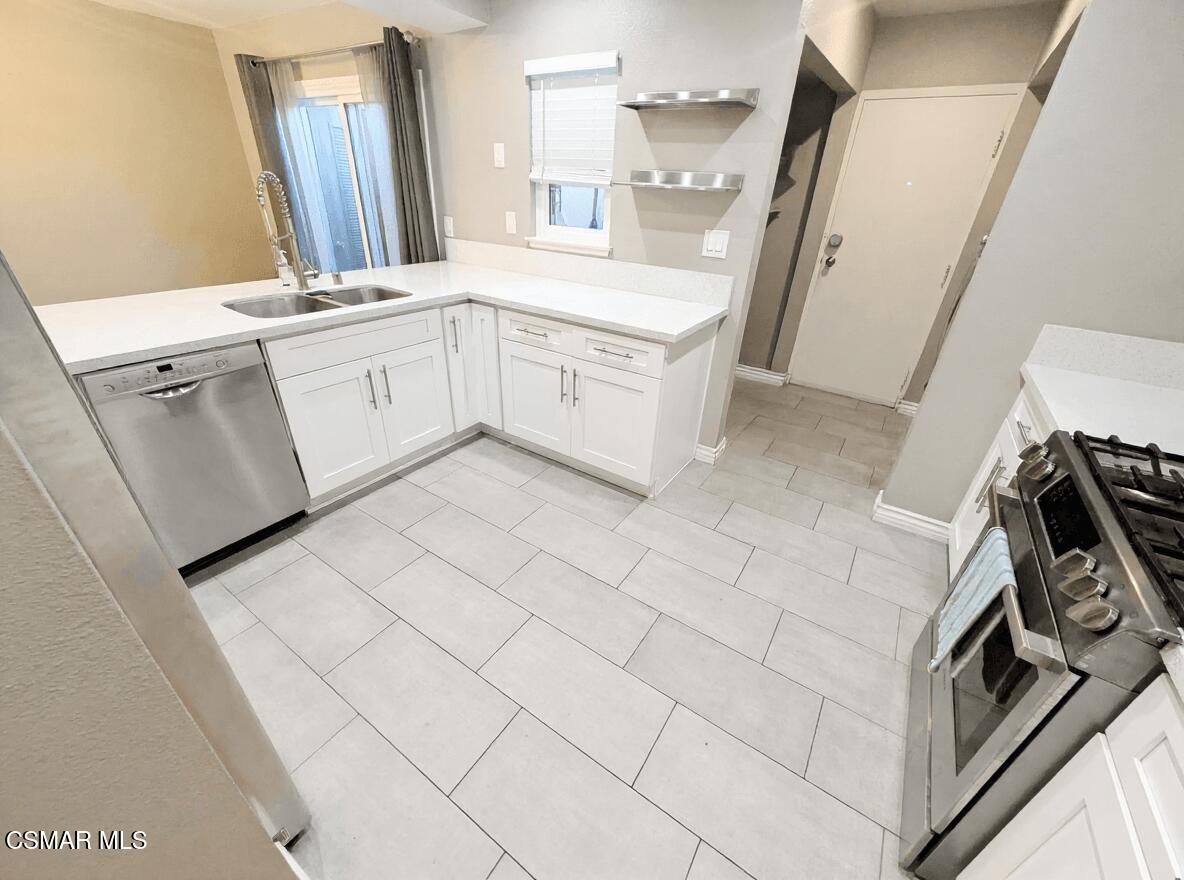 28713 Conejo View Drive Agoura Hills, CA 91301 - Photo 10 of 28 a kitchen with a sink stove and cabinets