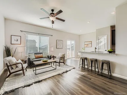 a living room with furniture and a wooden floor