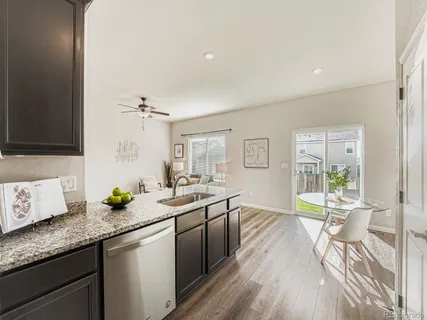 a spacious bathroom with a granite countertop sink a toilet and a mirror