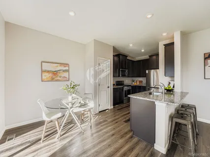 a kitchen with granite countertop appliances a sink and a refrigerator