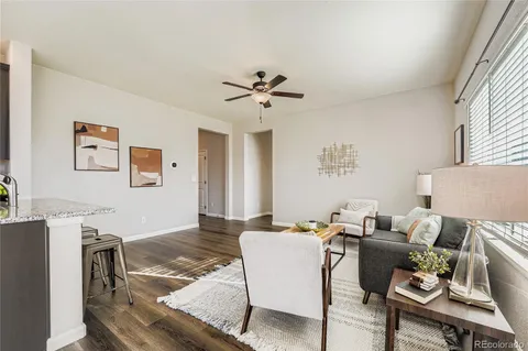 a living room with furniture and a chandelier