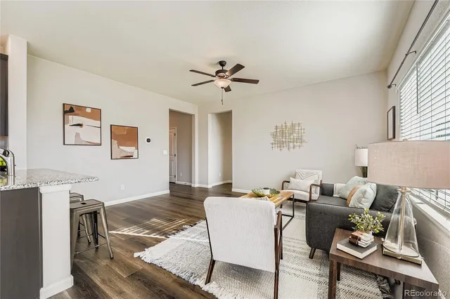 a living room with furniture and a chandelier