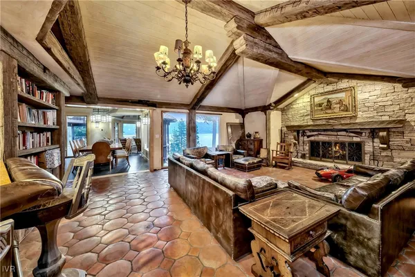 a living room with lots of furniture and a chandelier