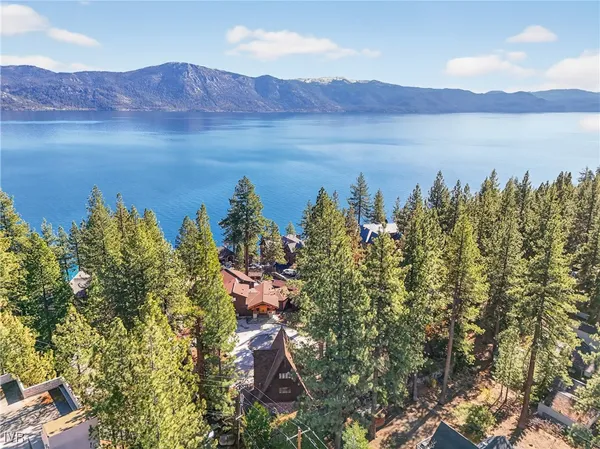 a view of lake with mountain and trees in the background