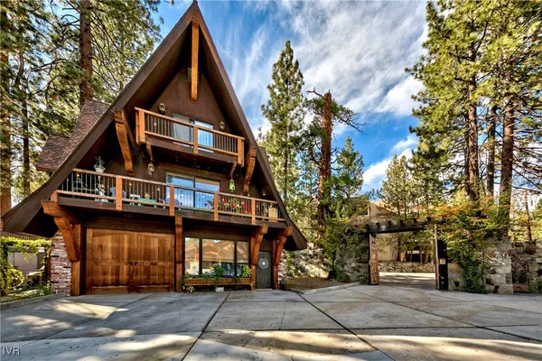 a kitchen with stainless steel appliances granite countertop a table chairs stove and refrigerator