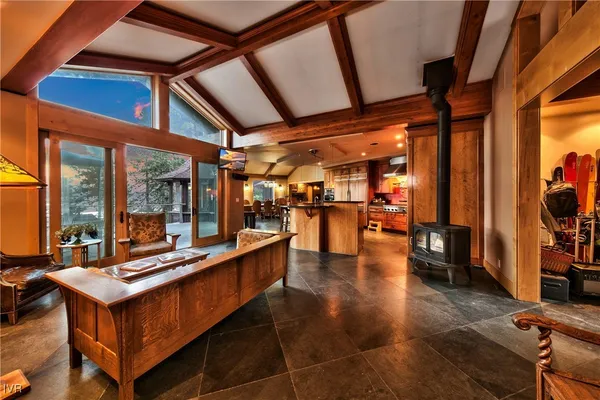 a view of a living room with furniture and floor to ceiling window