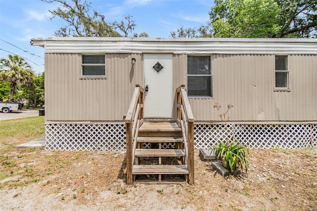 6608 Celeste Lane New Port Richey, FL 34653 - Photo 1 of 1 a view of a white house with a large window and wooden fence