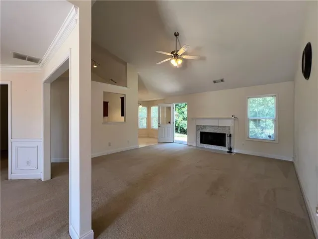 a view of an empty room with a fireplace